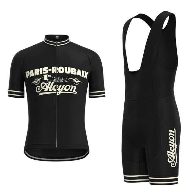 The Paris-Roubaix Retro Cycling Jersey Set includes a black short-sleeve jersey and bib shorts adorned with Paris-Roubaix and Alcyon. It features sleeve stripes, a breathable gel seat pad, and a performance design that accentuates its vintage-inspired theme.