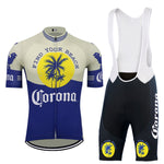 The Corona Beer Retro Cycling Jersey Set includes a blue and beige jersey with a full-length zipper and palm tree designs, along with black and blue bib shorts featuring palm trees, the Corona logo, and a gel seat pad for comfort.