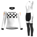The Womens 1960s Peugeot-Shell Retro Cycling Jersey Long Set features a retro white jacket with Peugeot on the chest, complemented by a black-and-white checkered pattern and long sleeves with logos. The accompanying bib is sleekly black from the waist down and also reads Peugeot.