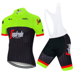 The Segafredo Zanetti Cycling Jersey Set features a bright green and black short-sleeve jersey with a front zipper, Segafredo Zanetti text, and matching bib shorts. The shorts have distinctive red and green stripes at the bottom, combining style and performance for any cyclist.