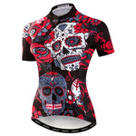 The Womens Black-Red Skull Cycling Jersey features a lightweight polyester design with colorful sugar skulls and floral patterns in red, white, and gray on a black backdrop, intricately adorning the front of this performance cycling jersey.