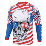 The USA Skull Long Sleeve Cycling Jersey showcases a skull with sunglasses featuring an American flag design. Red and white stripes form the background, while blue sections with white stars are on the sleeves and shoulders.