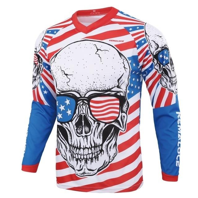 The USA Skull Long Sleeve Cycling Jersey showcases a skull with sunglasses featuring an American flag design. Red and white stripes form the background, while blue sections with white stars are on the sleeves and shoulders.