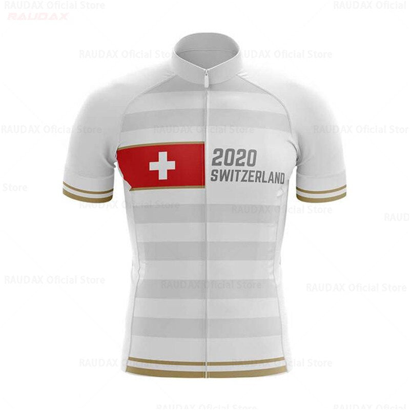 White & Gold Swiss Pro Team Cycling Jersey in lightweight polyester features gray stripes, the Swiss flag with 2020 SWITZERLAND on the front, gold-accented short sleeves, and a full-length zipper. Displayed on a plain backdrop.