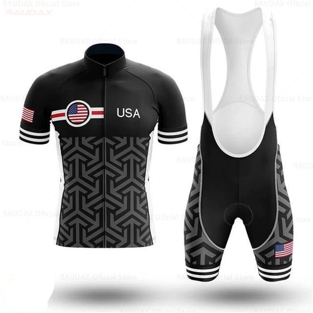 The USA Patterned Cycling Team Jersey Set includes a black and white cycling jersey with geometric designs, an American flag, a circular stars and stripes logo, and bold USA text. The sleeves have striped bands in the flags colors, completing the striking look.