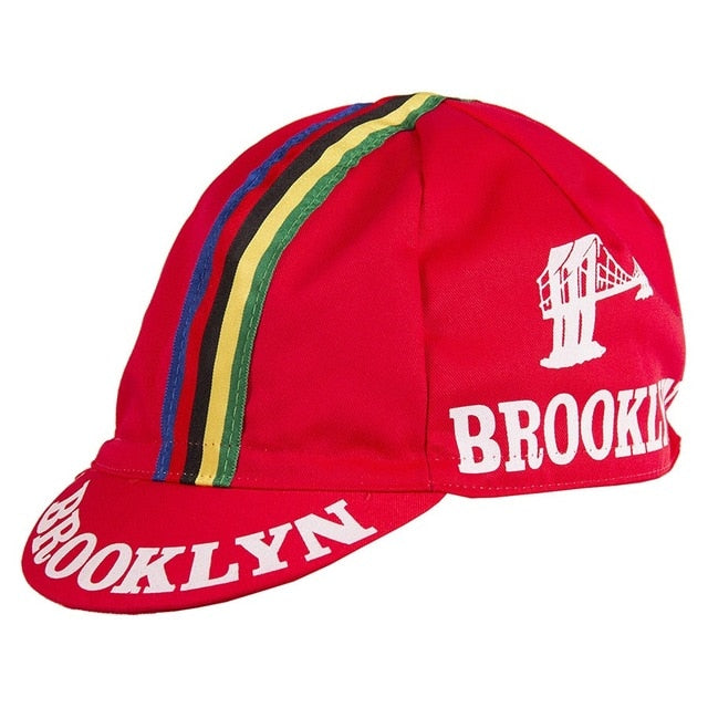 The Brooklyn Retro Cycling Caps feature a classic multicolored striped design with Brooklyn text on the brim and side, a white bridge graphic nodding to Brooklyn Chewing Gum, evoking nostalgia on every ride.