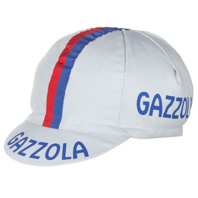 The Gazzola Retro Cycling Cap is light gray with a red and blue stripe from front to back, featuring GAZZOLA in blue on the side and brim for a classic retro look.