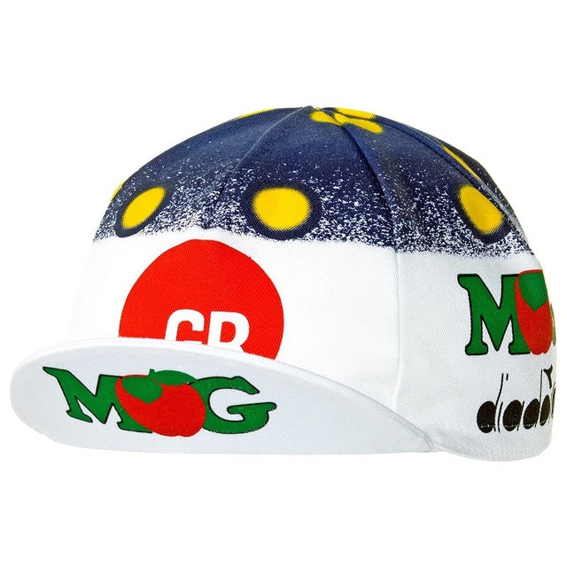 The GB-MG Maglificio Retro Cycling Cap features a classic design with a blue and white gradient and yellow dots. It displays CB and MG logos encircled in red, adorned with tomato graphics, plus text and imagery on the brim.