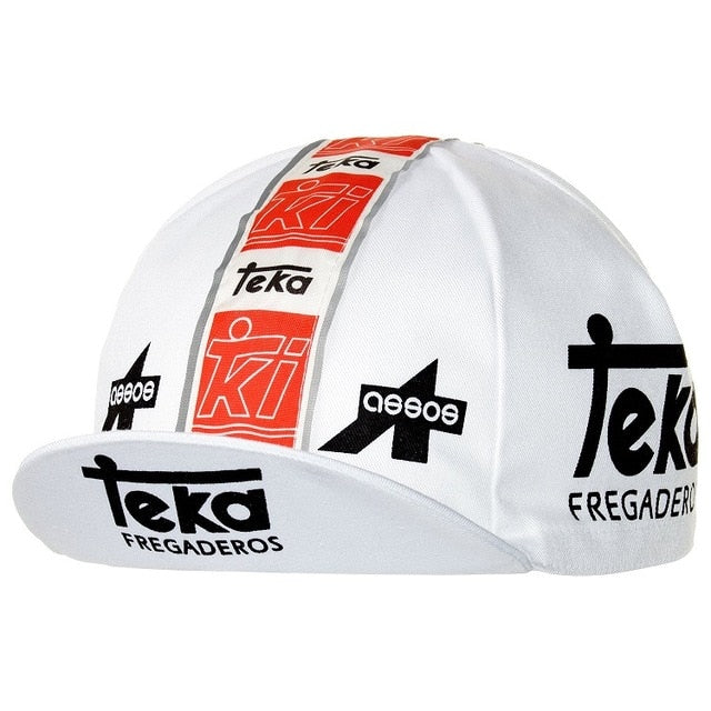 The Teka Fregaderos Retro Cycling Cap features a white retro design with bold black Teka Fregaderos text on the side, multiple red and black logos like Teka and assos along a central stripe, and a short brim for vintage flair.