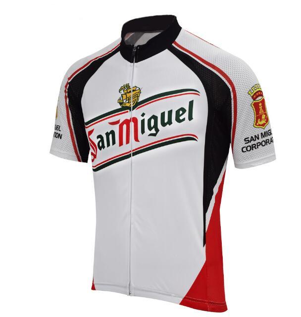 The San Miguel Beer Cycling Jersey features San Miguel in green and red on the front, accented with black and red. The sleeves show a red crest and black San Miguel Corporation text. It includes a stylish black collar and zippered front for added functionality.