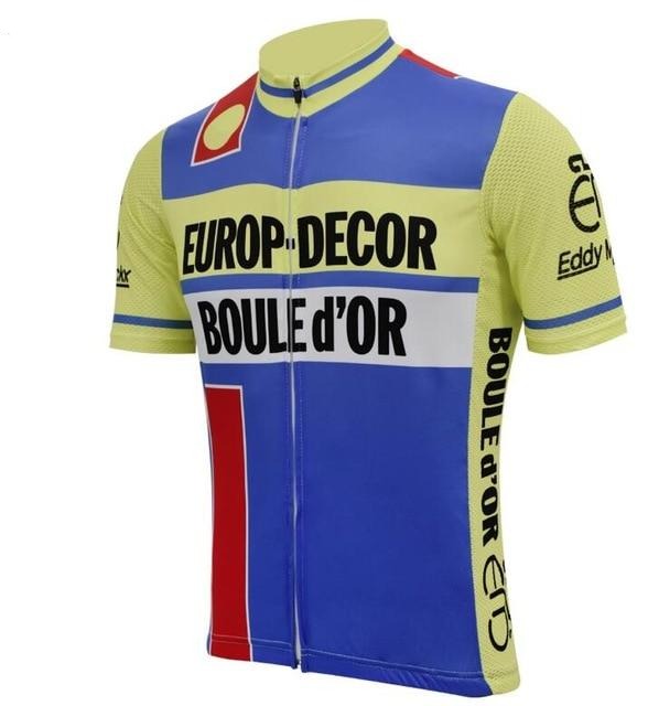 The Europ Decor Boule dOr 1984 Retro Cycling Jersey features a vibrant yellow, blue, and red color scheme, crafted from lightweight polyester. It prominently displays EUROP DECOR BOULE D’OR on the front, with unique logos and patterns highlighting the sleeves and collar.