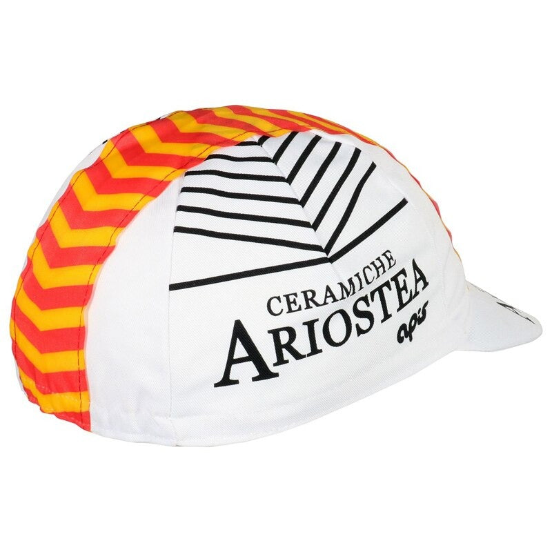 The Ceramiche Ariostea Retro Cycling Cap showcases a vibrant, classic design with a white base, black side text, orange and yellow chevron patterns on top, and a small white brim featuring the logo.