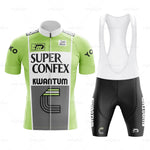 The Super Confex Kwantum Retro Cycling Jersey Set features a green and white jersey with Super Confex and Kwantum text, front zipper, short sleeves, and black bib shorts. Made from lightweight polyester for comfort.