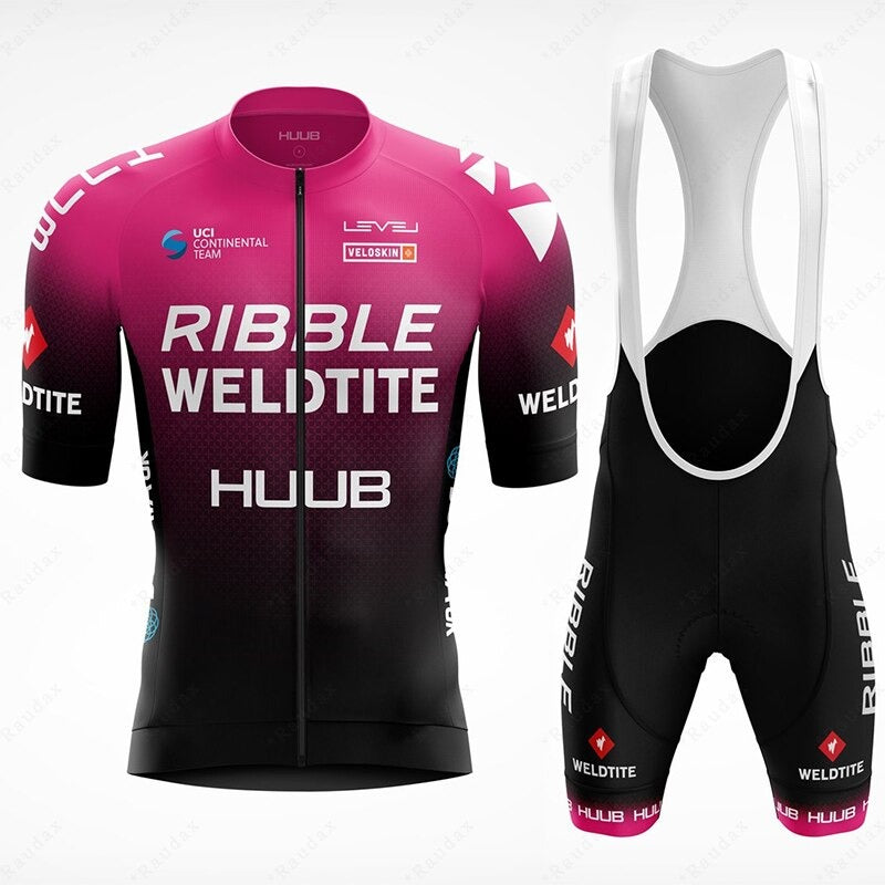 The Ribble Weldtite Huub Cycling Team Jersey Set features a pink and black gradient jersey with black bib shorts, adorned with Ribble, Weldtite, and Huub logos, blending performance and style for serious cyclists.