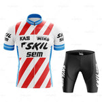 The KAS Skil Sem Retro Cycling Jersey Set boasts red diagonal stripes, logos with blue accents on the sleeves and collar, and black cycling shorts with white text, all designed for breathable performance comfort.