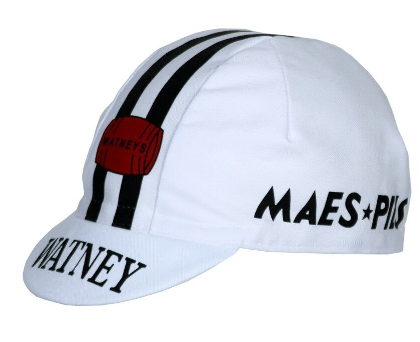The Watney Beer Retro Cycling Cap features a classic white design with two black stripes down the center, WATNEY and MAES PILS in black lettering on the front, and a distinctive red barrel logo reminiscent of Watney Beer.