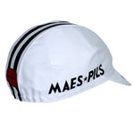 The Watney Beer Retro Cycling Cap is white with two black center stripes and MAES P*ILS on the side. A partially visible red circle with black text enhances its vintage style.